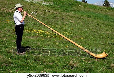 Stock Photography - single man playing alphorn, International Alphorn Festival, 27-29 July 2013, Nendaz, canton Valais, canton Wallis, Switzerland.. Fotosearch