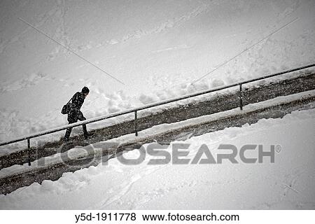 single man walking up the road in heavy snowfall, Geneva, Switzerland View Large Photo Image Stock Photo - single man walking up the road in heavy snowfall, Geneva, Switzerland. Fotosearch