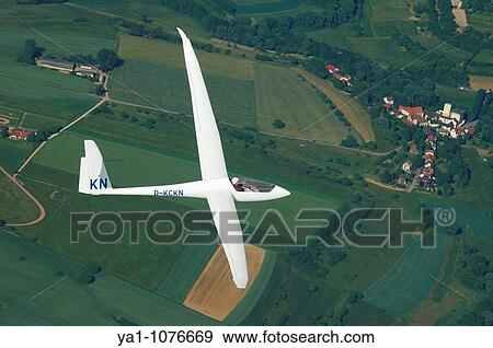 Stock Photo - Single seat glider Discus 2cT in flight over french Lorraine countryside - France. Fotosearch