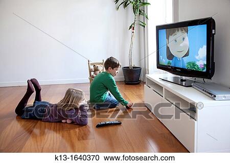 Sister and brother watching TV at home View Large Photo Image Stock Image - Sister and brother watching TV at home. Fotosearch
