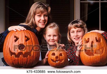 Sisters and jack o? lanterns View Large Photo Image Stock Photography - Sisters and jack o? lanterns. Fotosearch