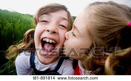 sisters kissing View Large Photo Image Picture - sisters kissing. Fotosearch