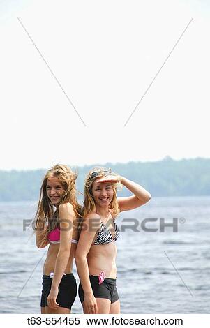 sisters standing on dock together looking out View Large Photo Image Stock Photography - sisters standing on dock together looking out. Fotosearch