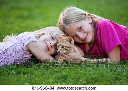 sisters with kitten View Large Photo Image Picture - sisters with kitten. Fotosearch