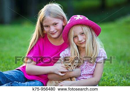 sisters with kitten View Large Photo Image Stock Image - sisters with kitten. Fotosearch