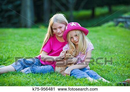 Stock Image - sisters with kitten. Fotosearch