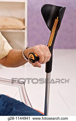 sitting senior hand holding a crutch View Large Photo Image Stock Image - sitting senior hand holding a crutch. Fotosearch