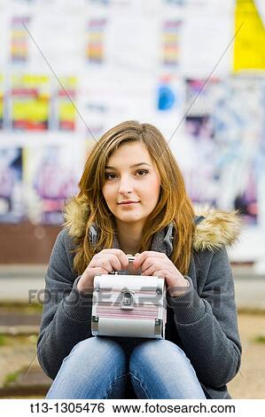 Sitting with a box bag in hand young woman View Large Photo Image Stock Photograph - Sitting with a box bag in hand young woman. Fotosearch