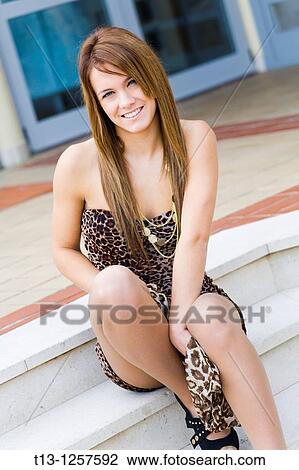 Sitting young woman with a scarf between her legs View Large Photo Image Stock Image - Sitting young woman with a scarf between her legs. Fotosearch