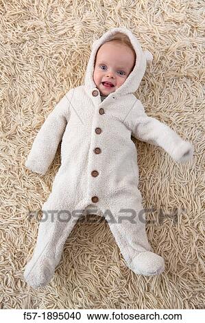 Six month year old baby lying on a rug View Large Photo Image Stock Image - Six month year old baby lying on a rug. Fotosearch