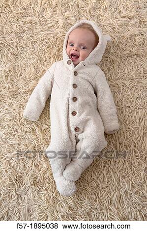 Six month year old baby lying on a rug View Large Photo Image Stock Photo - Six month year old baby lying on a rug. Fotosearch