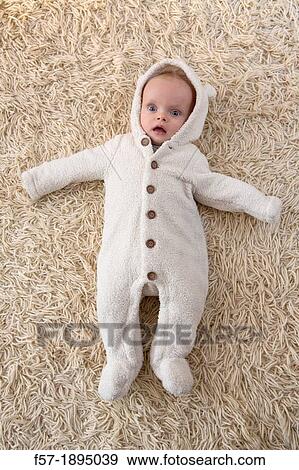 Six month year old baby lying on a rug View Large Photo Image Stock Photo - Six month year old baby lying on a rug. Fotosearch