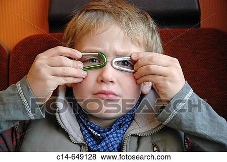 Stock Photo - Six-year boy jokes with carbine. Fotosearch
