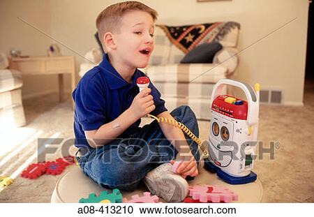 Six year old boy practices his singing into a toy recorder. View Large Photo Image Stock Image - Six year old boy practices his singing into a toy recorder.. Fotosearch