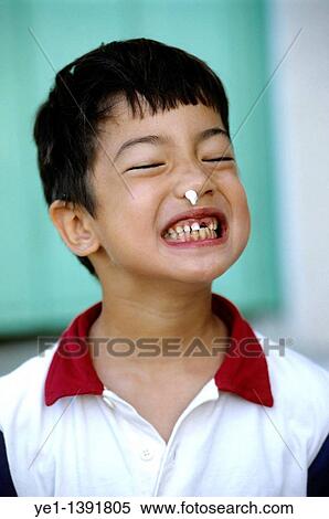 Six year old boy with a missing tooth making a silly face, France View Large Photo Image Stock Photography - Six year old boy with a missing tooth making a silly face, France. Fotosearch