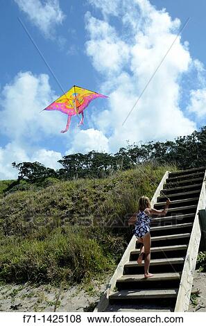 Six year old girl flying a kite at the beach Mimiwhangata, Northland, New Zealand View Large Photo Image Stock Photo - Six year old girl flying a kite at the beach Mimiwhangata, Northland, New Zealand. Fotosearch