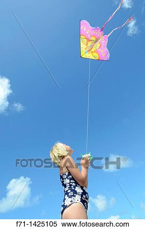 Six year old girl flying a kite at the beach Mimiwhangata, Northland, New Zealand View Large Photo Image Stock Photography - Six year old girl flying a kite at the beach Mimiwhangata, Northland, New Zealand. Fotosearch
