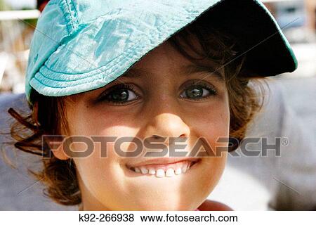 Six-year-old girl in a large baseball hat View Large Photo Image Stock Photo - Six-year-old girl in a large baseball hat. Fotosearch
