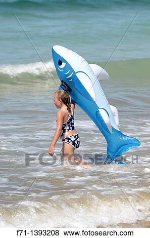 Six year old girld playing in the surf on inflatable shark Mimiwhangata Northland, New Zealand View Large Photo Image Stock Photo - Six year old girld playing in the surf on inflatable shark Mimiwhangata Northland, New Zealand. Fotosearch