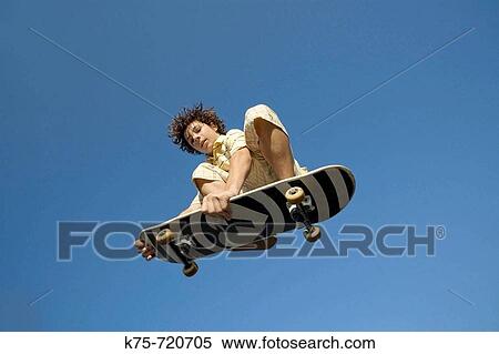 Skateboarder in the air View Large Photo Image Stock Photography - Skateboarder in the air. Fotosearch