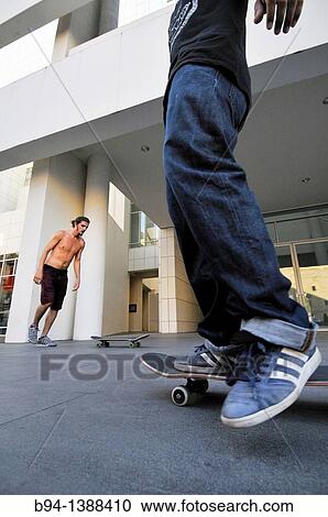 Stock Image - Skateboarders in Pla? a dels Pla? a dels? ngels in front of MACBA (Museum of Contemporary Art, 1987-95, designed by Richard Meier), Barcelona. Catalonia, Spain. Fotosearch