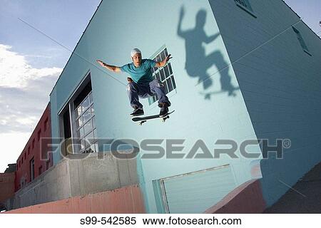 Skater skateboarding behind a building in downtown Kansas City, Missouri, USA View Large Photo Image Stock Photography - Skater skateboarding behind a building in downtown Kansas City, Missouri, USA. Fotosearch