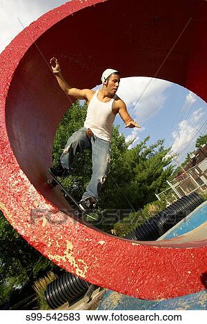 Skater skateboarding in red tube at a skate park in Kansas City, Missouri, USA View Large Photo Image Stock Image - Skater skateboarding in red tube at a skate park in Kansas City, Missouri, USA. Fotosearch