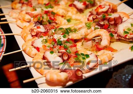 Skewer shrimp and octopus,? pintxos? at Bar Txalupa in old town, Donostia (San Sebastian), Basque Country, Spain View Large Photo Image Stock Photography - Skewer shrimp and octopus,? pintxos? at Bar Txalupa in old town, Donostia (San Sebastian), Basque Country, Spain. Fotosearch