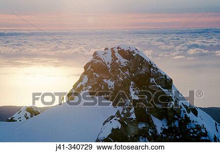 Ski mountaineer. Drummond peak. Sunset over Tasman sea. Westland national park. New Zealand. View Large Photo Image Stock Photo - Ski mountaineer. Drummond peak. Sunset over Tasman sea. Westland national park. New Zealand.. Fotosearch