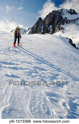 Stock Photo - Ski mountaineering in the evening near the Amitges mountain hut, Pallars Sobir?, Pyrenees Mountains, Aig? estortes and Estany de Sant Maurici National Park, Lleida province, Catalonia, Spain. Fotosearch
