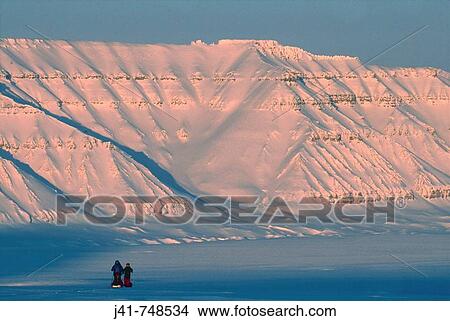Ski tourers hauling sledges on spring traverse Ny Alesund to Longyearbyen Spitsbergen Island Svalbard Norwegian Arctic View Large Photo Image Picture - Ski tourers hauling sledges on spring traverse Ny Alesund to Longyearbyen Spitsbergen Island Svalbard Norwegian Arctic. Fotosearch