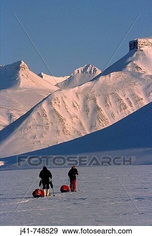 Ski tourers hauling sledges on spring traverse Ny Alesund to Longyearbyen Spitsbergen Island Svalbard Norwegian Arctic View Large Photo Image Stock Photo - Ski tourers hauling sledges on spring traverse Ny Alesund to Longyearbyen Spitsbergen Island Svalbard Norwegian Arctic. Fotosearch