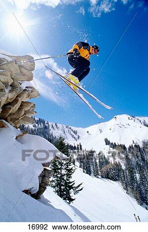 Stock Image - Skier jumping off cliff. Fotosearch