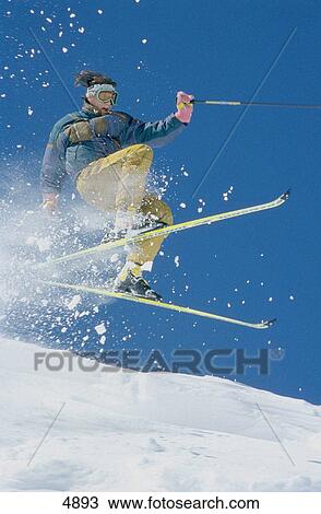 Stock Image - Skier jumping off cornice. Fotosearch