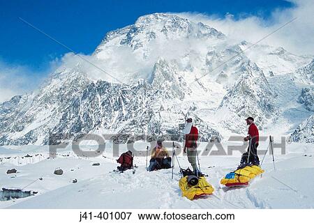 Skiers hauling sleds under Broad Peak, Godwin-Austen glacier. Karakoram mountains, Pakistan View Large Photo Image Stock Photo - Skiers hauling sleds under Broad Peak, Godwin-Austen glacier. Karakoram mountains, Pakistan. Fotosearch