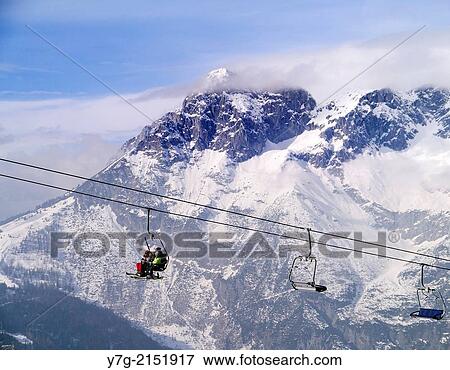Skiers on a chairlift, Werfenweng, Salzburg, Austria, Europe. View Large Photo Image Stock Photo - Skiers on a chairlift, Werfenweng, Salzburg, Austria, Europe.. Fotosearch