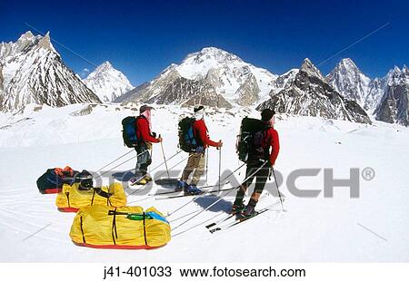 Stock Image - Skiers reach Concordia with K2 behind, Baltoro and Godwin-Austin Glaciers junction. Karakoram mountains, Pakistan. Fotosearch