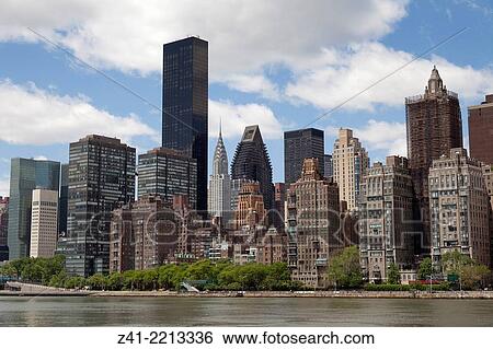 Stock Photograph - Skyline of Manhattan with the Chrysler building seen from Roosevelt Island, New York City.. Fotosearch