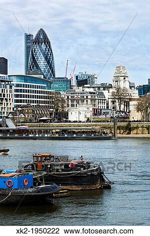 Skyline with Thames boat and Swiss Re (Gherkin) building, London, UK View Large Photo Image Stock Image - Skyline with Thames boat and Swiss Re (Gherkin) building, London, UK. Fotosearch