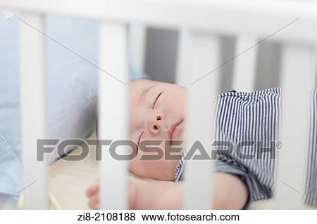 Sleeping baby in cot View Large Photo Image Stock Photo - Sleeping baby in cot. Fotosearch