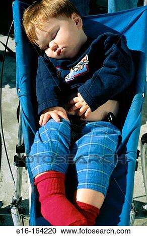 Stock Image - Sleeping baby in stroller. Fotosearch