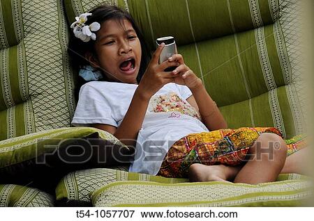 Sleepy Thai Girl play with Phone View Large Photo Image Stock Photo - Sleepy Thai Girl play with Phone. Fotosearch