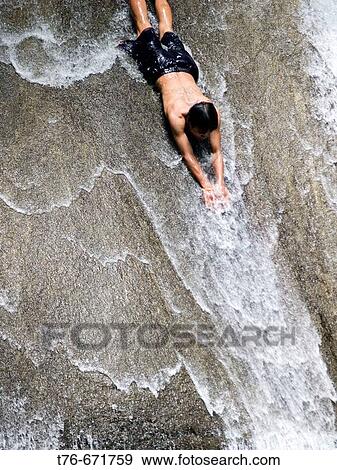 Sliding down the waterfall at Erawan Falls National Park, Thailand View Large Photo Image Stock Photo - Sliding down the waterfall at Erawan Falls National Park, Thailand. Fotosearch