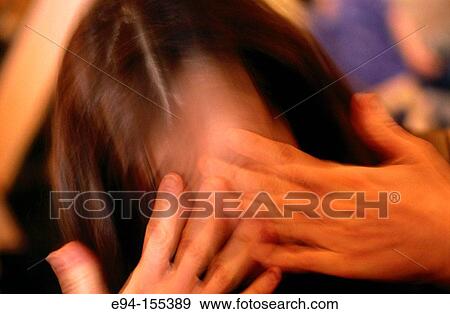 Slightly blurred photo of a young woman holding her hands over her eyes View Large Photo Image Stock Photo - Slightly blurred photo of a young woman holding her hands over her eyes. Fotosearch