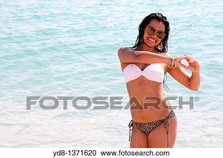 Smailing young woman and looking at the camera in Miami Beach, Florida, USA View Large Photo Image Stock Image - Smailing young woman and looking at the camera in Miami Beach, Florida, USA. Fotosearch