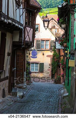 Small alley and timbered houses in Riquewihr, Alsace, France View Large Photo Image Stock Photo - Small alley and timbered houses in Riquewihr, Alsace, France. Fotosearch