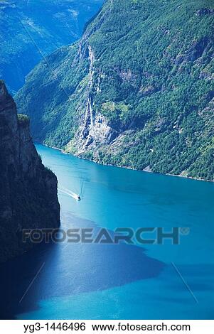 Small boat in Geiranger Fjord, Norway View Large Photo Image Stock Photograph - Small boat in Geiranger Fjord, Norway. Fotosearch