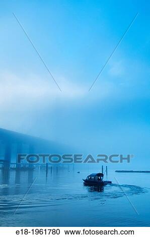 Small boat turning in the water of the Fraser River near the Port Mann Bridge at dawn, Coquitlam, British Columbia, Canada View Large Photo Image Stock Image - Small boat turning in the water of the Fraser River near the Port Mann Bridge at dawn, Coquitlam, British Columbia, Canada. Fotosearch