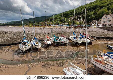 Small boats in Porlock Weir Harbour at low tide, Exmoor National Park, North Devon, England, UK, Europe View Large Photo Image Stock Photograph - Small boats in Porlock Weir Harbour at low tide, Exmoor National Park, North Devon, England, UK, Europe. Fotosearch