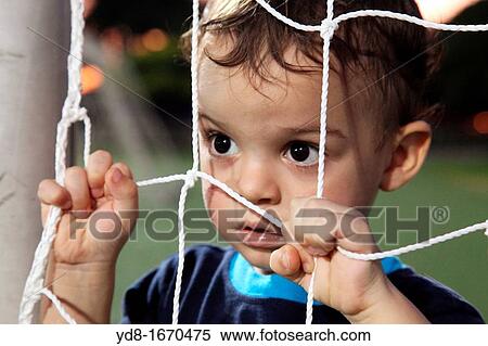 Small child watching a game futball View Large Photo Image Stock Photography - Small child watching a game futball. Fotosearch